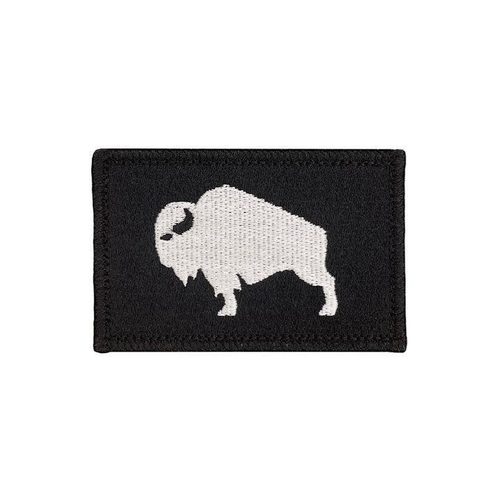 Black patch with a white silhouette of a bison on a white background