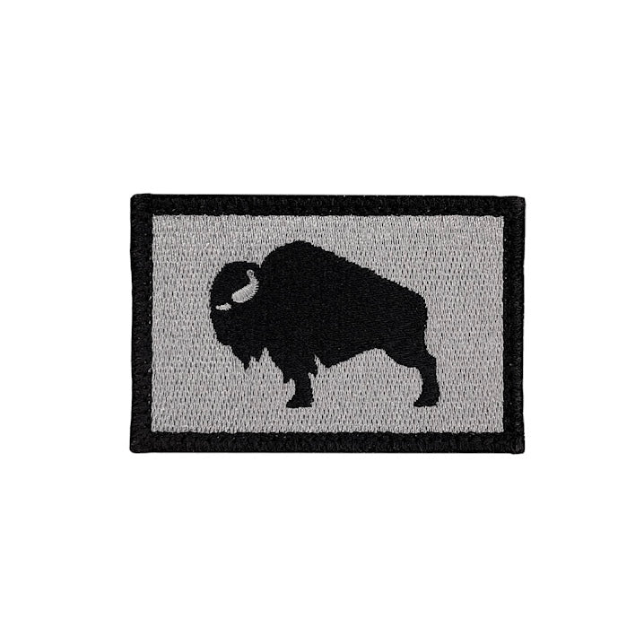 Patch with a black silhouette of a bison on a gray background