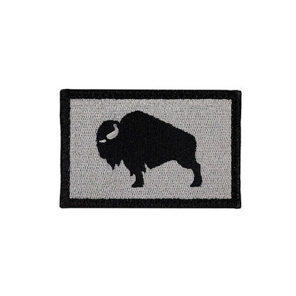 Patch with a black silhouette of a bison on a gray background